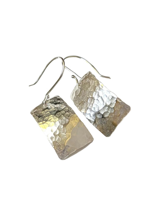 A pair of hammered rectangular silver earrings with fishhook wires, displayed on a clean white background.